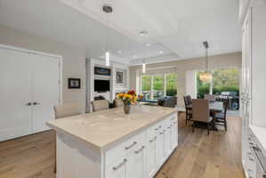 Kitchen island with light-toned countertop and white cabinetry