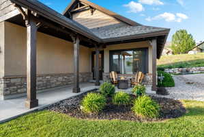 Stucco and stone facade with dark wood architectural accents
