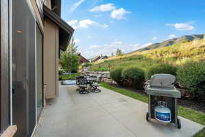 Expansive patio featuring a concrete surface and direct access to the interior via a sliding glass door