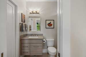 Contemporary vanity with stone-finish countertop and integrated sink