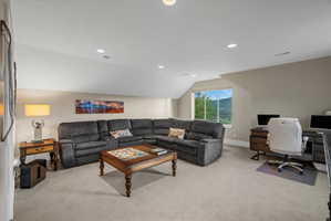 Spacious bonus room featuring neutral wall tones, recessed lighting, and a large window