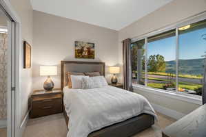 Bedroom featuring a large window, providing expansive views of the surrounding landscape