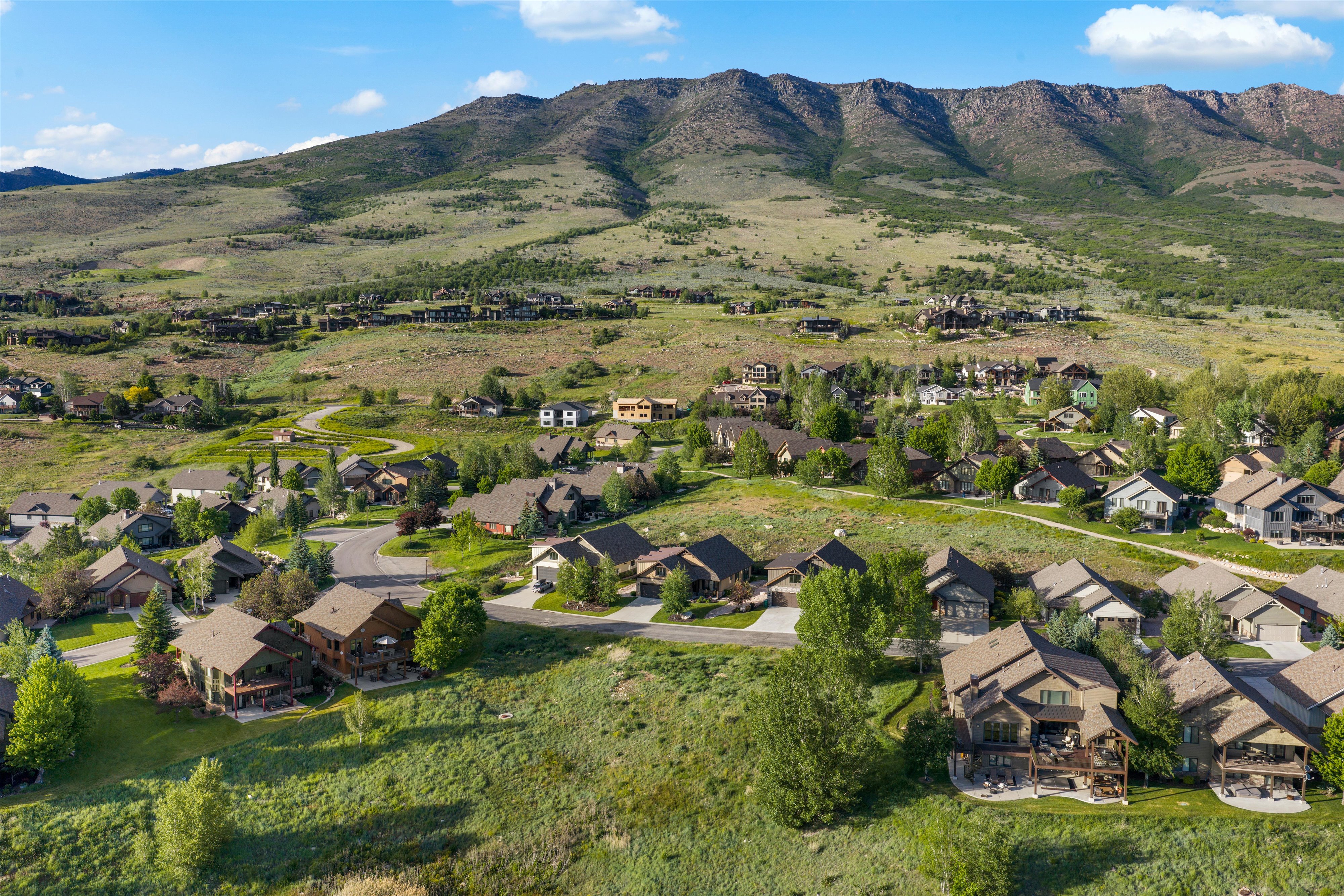 Expansive residential area nestled within a lush, mountainous landscape