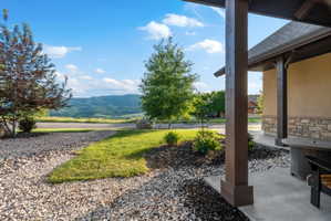 Covered patio with a concrete slab and robust wood columns