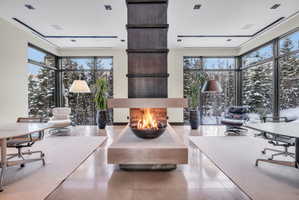 Central fireplace feature with an elevated hearth and integrated fire bowl
