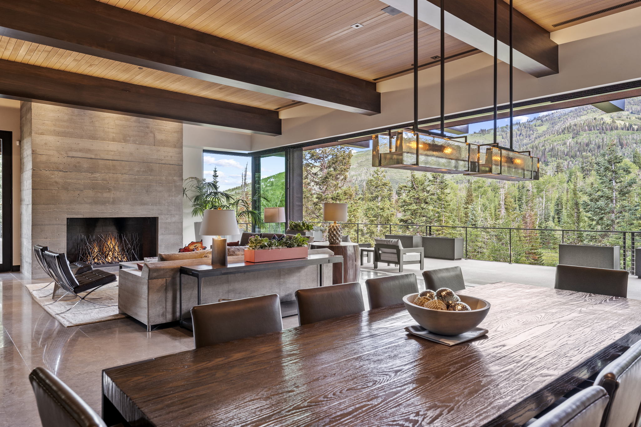 Expansive dining area with a long wood-finish table and leather-style chairs