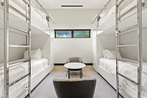 Modern bunk room featuring four built-in bunk beds with integrated ladders