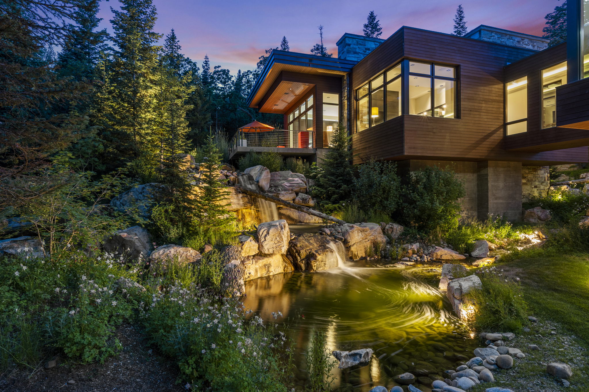 Modern architectural residence featuring extensive wood siding and large window arrays