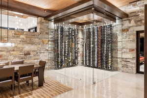 Custom glass-enclosed wine storage featuring built-in racks