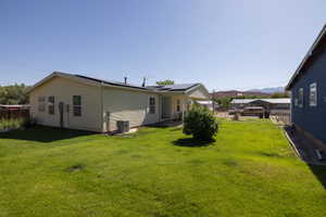 Expansive green lawn bordering a cream-colored siding residence