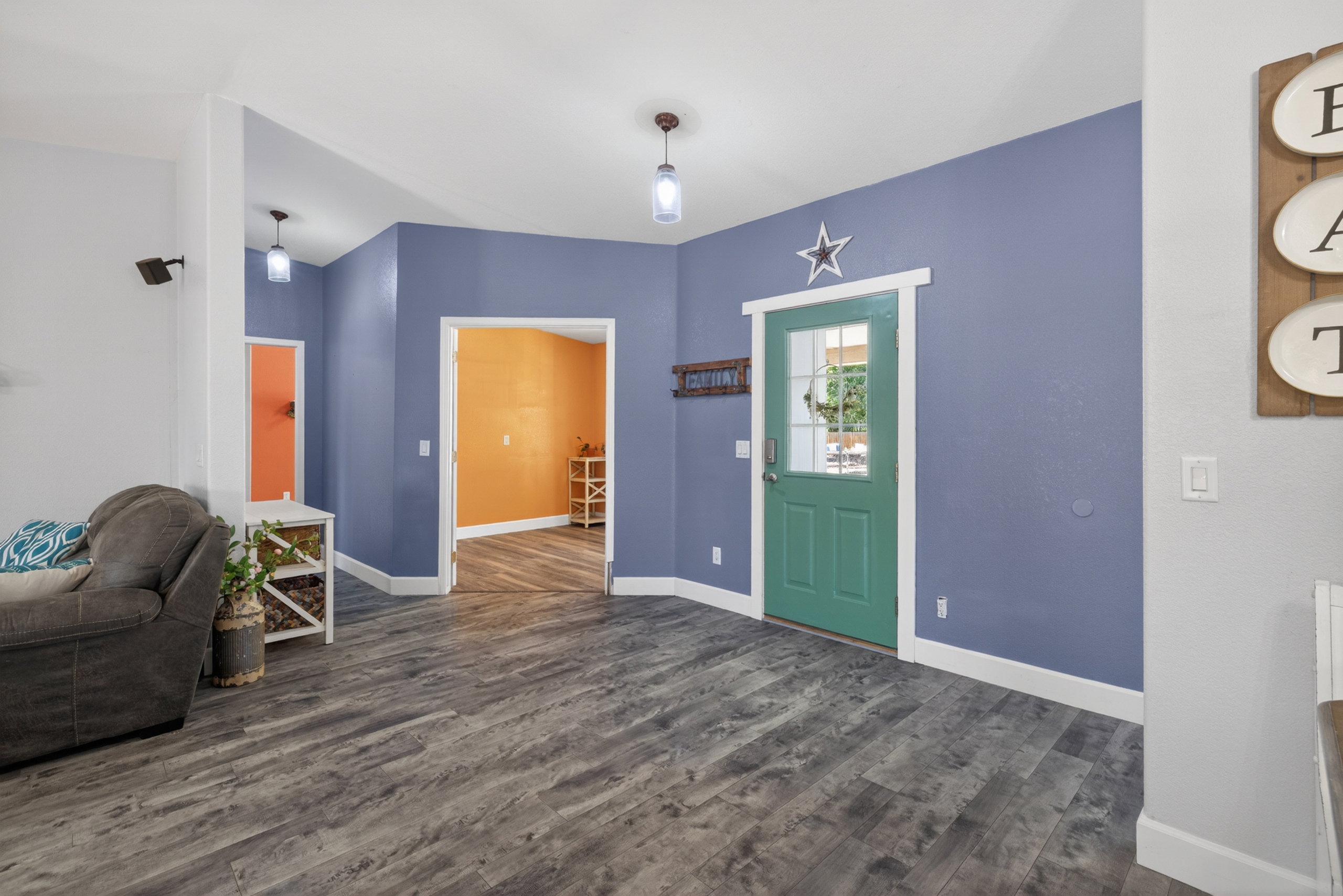 Entryway featuring wood-finish flooring and a green paneled door with glass inserts