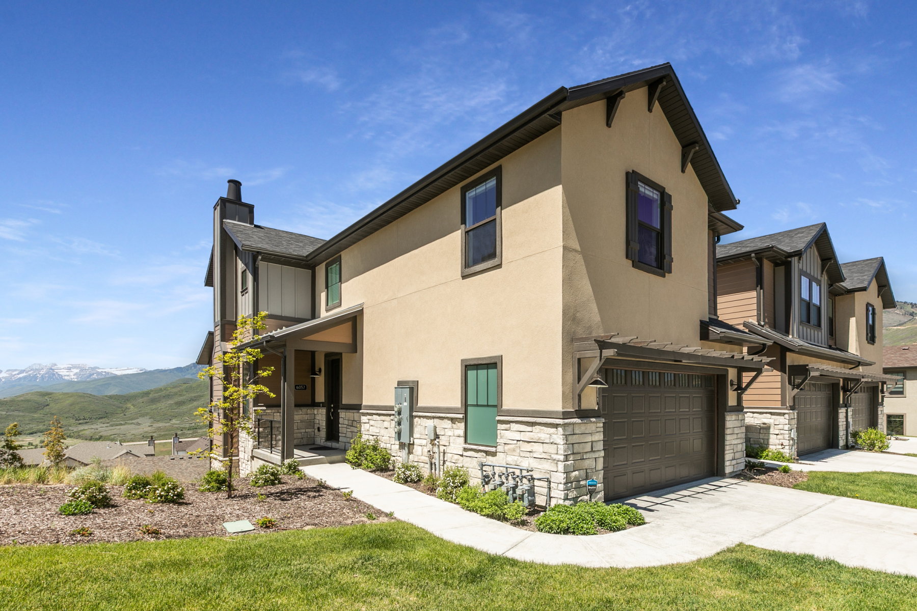 Contemporary multi-story exterior with stucco and stone accents