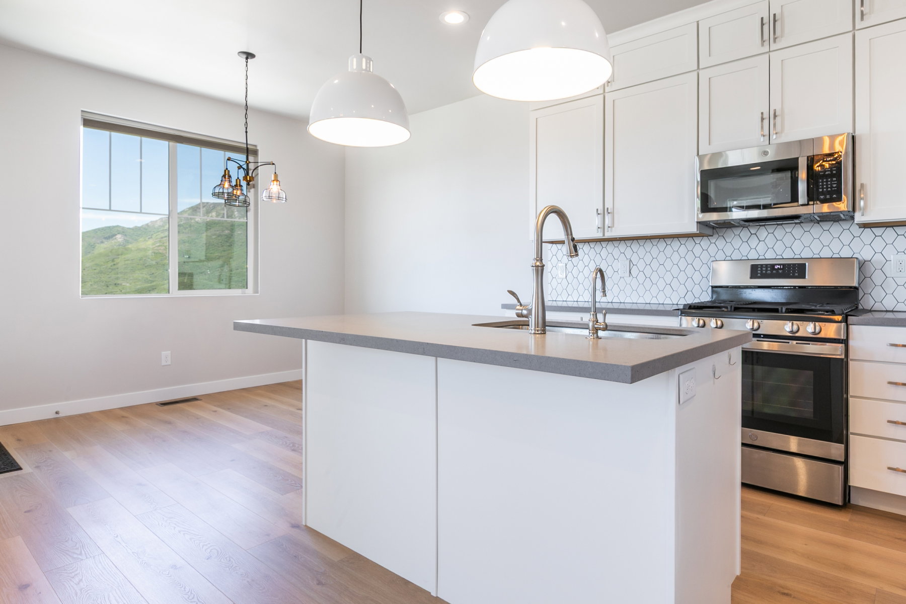 Modern kitchen island featuring a light gray countertop and integrated sink