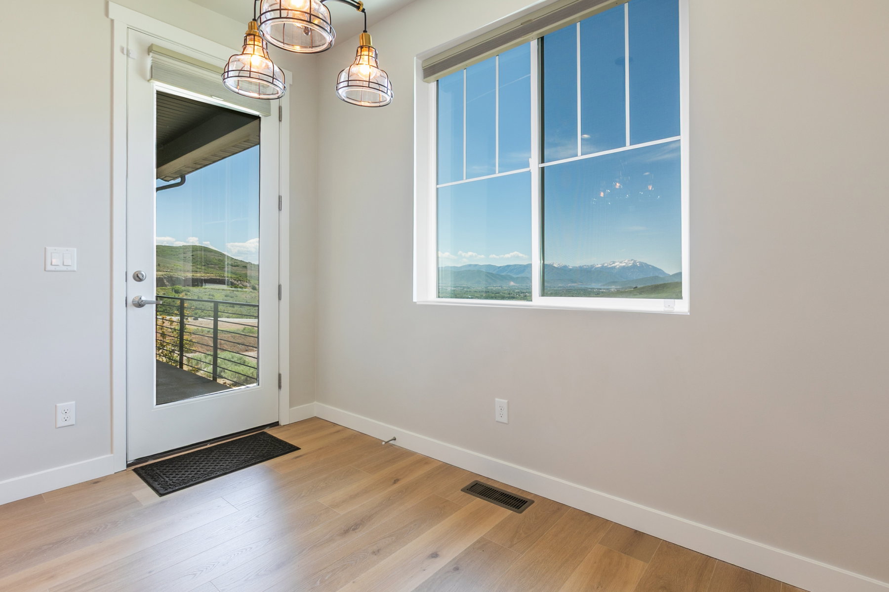 Natural light-filled interior with expansive windows and a glass-paneled door