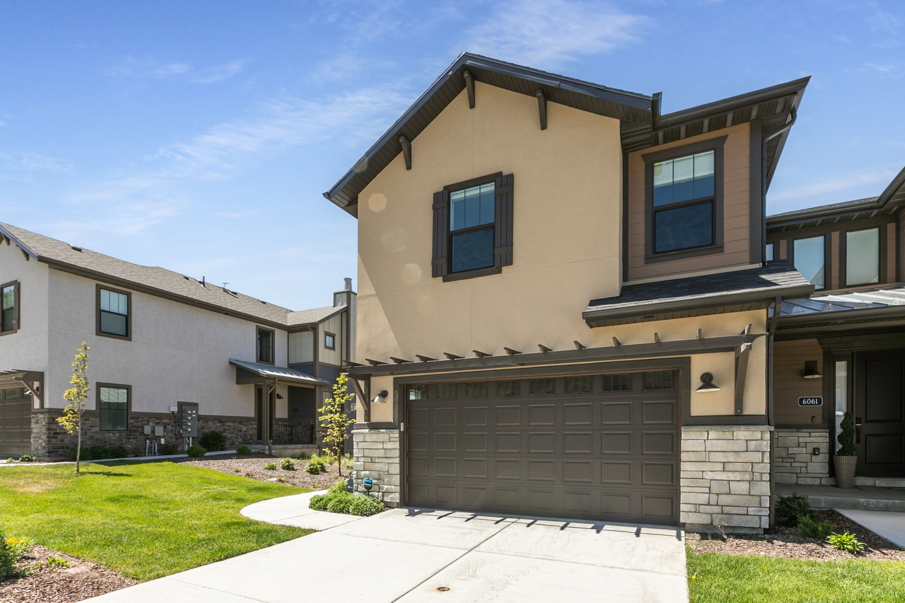 Contemporary exterior featuring stucco and stone veneer accents