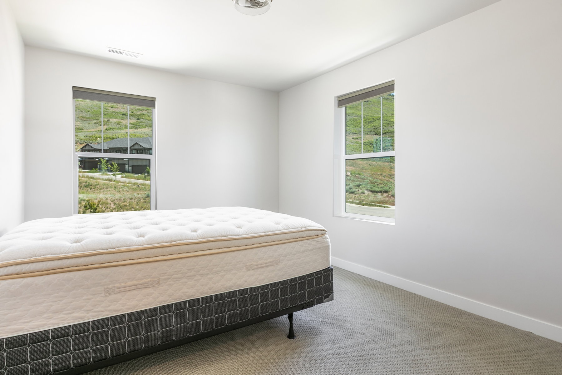 Bright room featuring two large windows with white frames