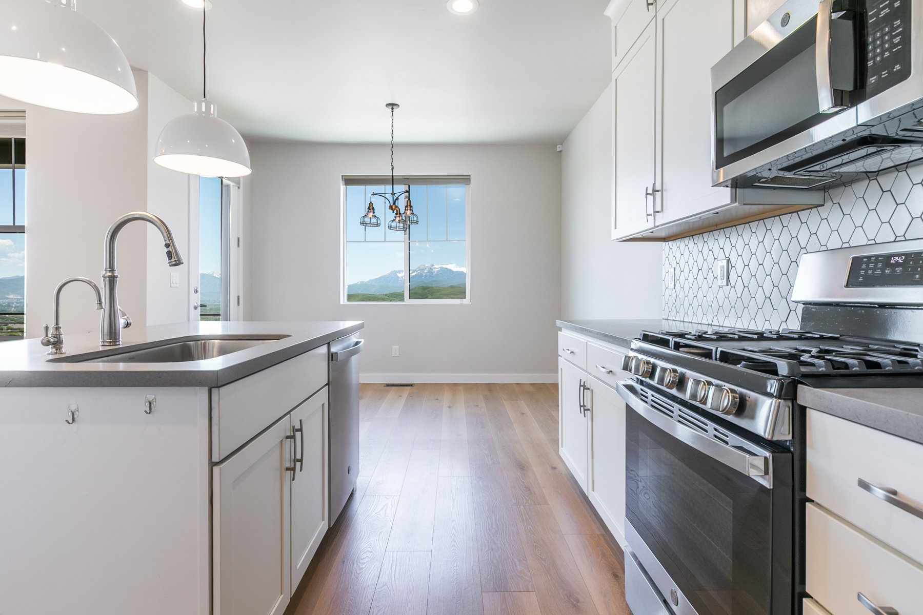 Modern kitchen featuring a stainless steel gas range, microwave, and dishwasher
