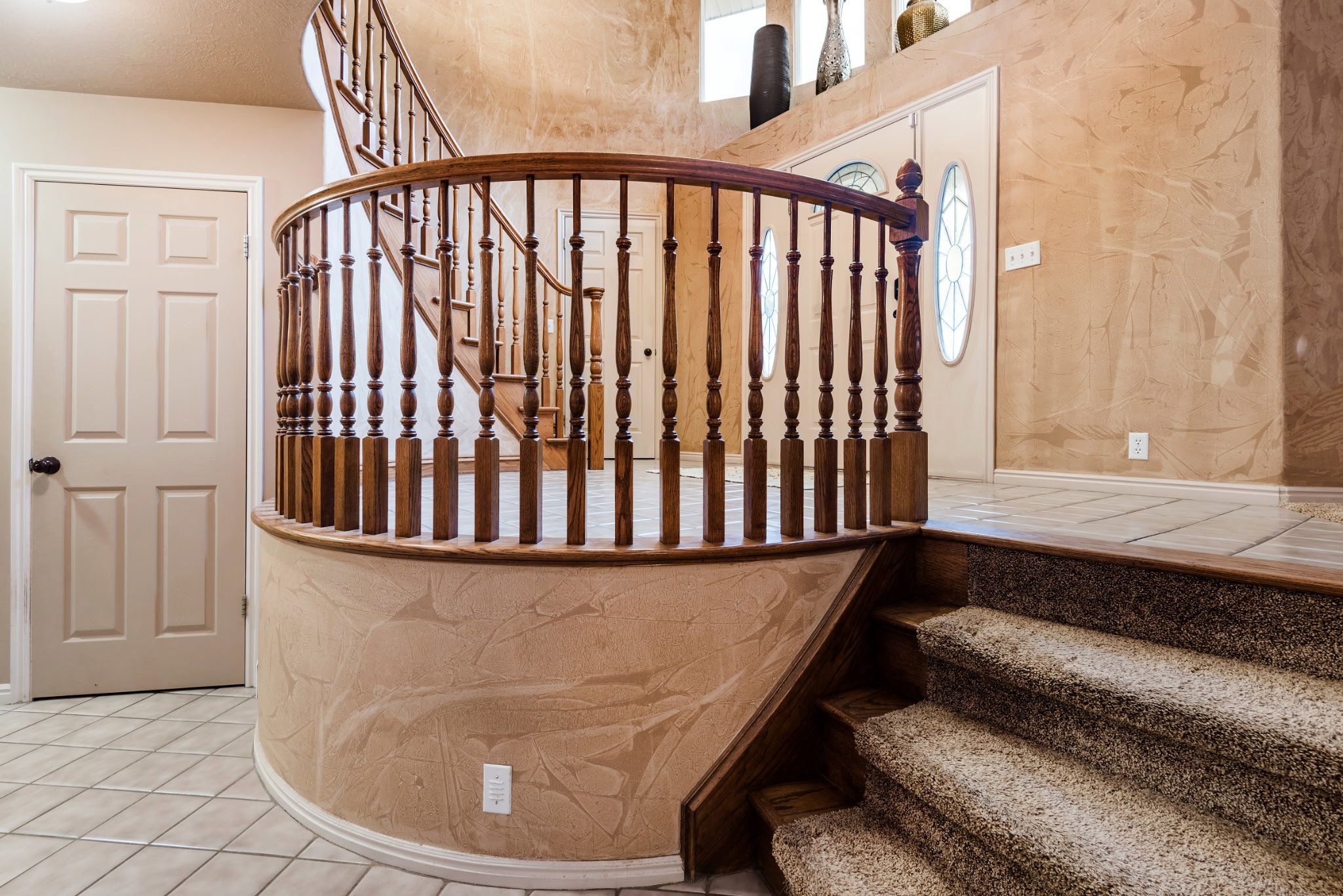 Curved staircase with wood balusters and handrail