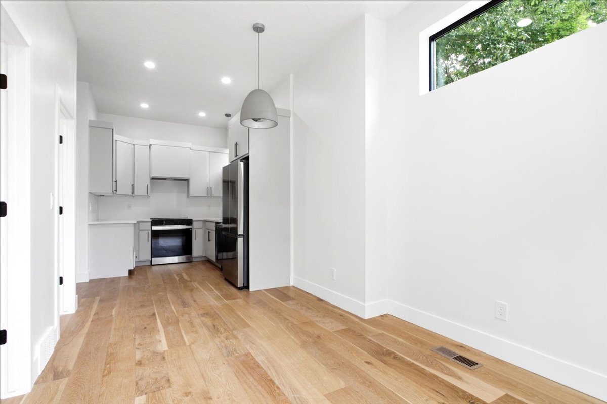 Open-concept living space with light wood-finish flooring