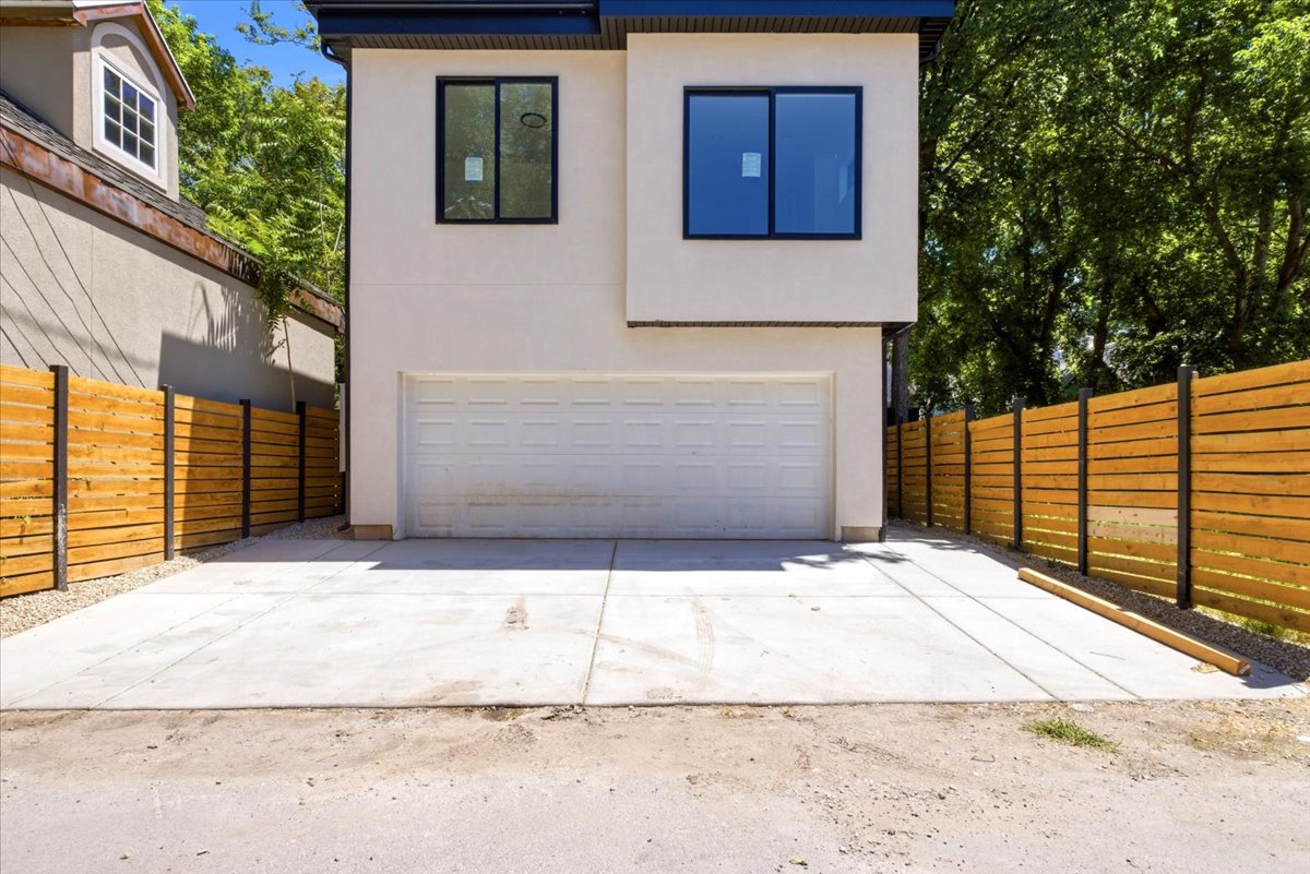 Modern facade featuring clean lines, a two-car garage, and a concrete driveway