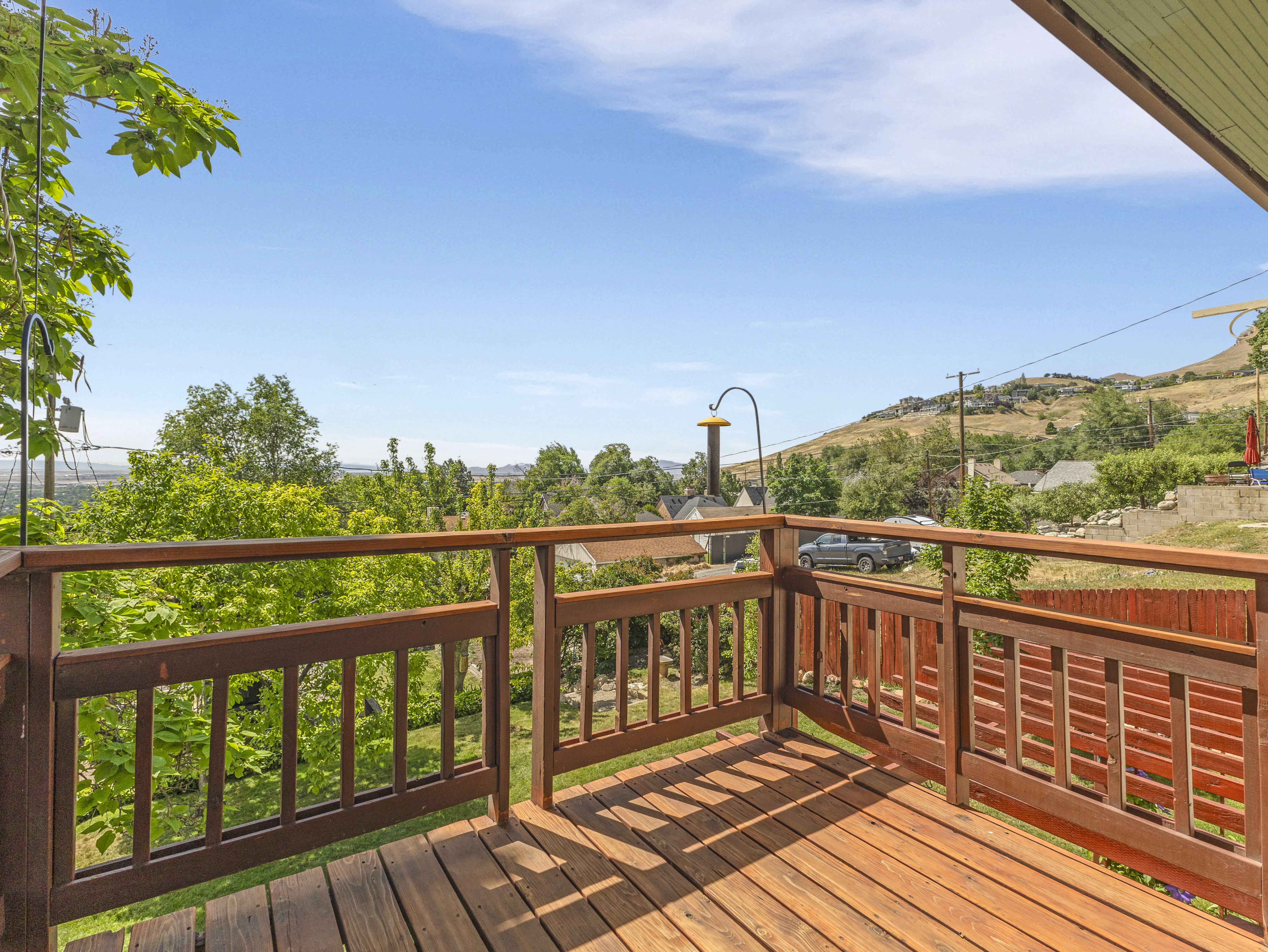 Expansive outdoor deck featuring wood-finish flooring and a matching wood-finish railing system