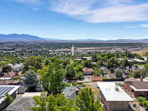 Expansive aerial perspective showcasing a broad urban landscape with distant mountain ranges