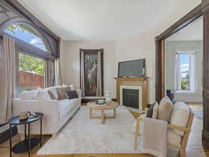 Living area featuring wood-finish flooring and a decorative fireplace with a light-toned mantel