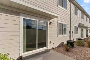 Sliding glass door leading to a concrete patio
