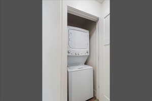 Dedicated laundry closet with a stacked washer and dryer