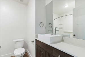 Contemporary bathroom featuring a vessel sink, chrome fixtures, dark wood-finish cabinetry, a white countertop, and a shower/tub combination with a curved rod
