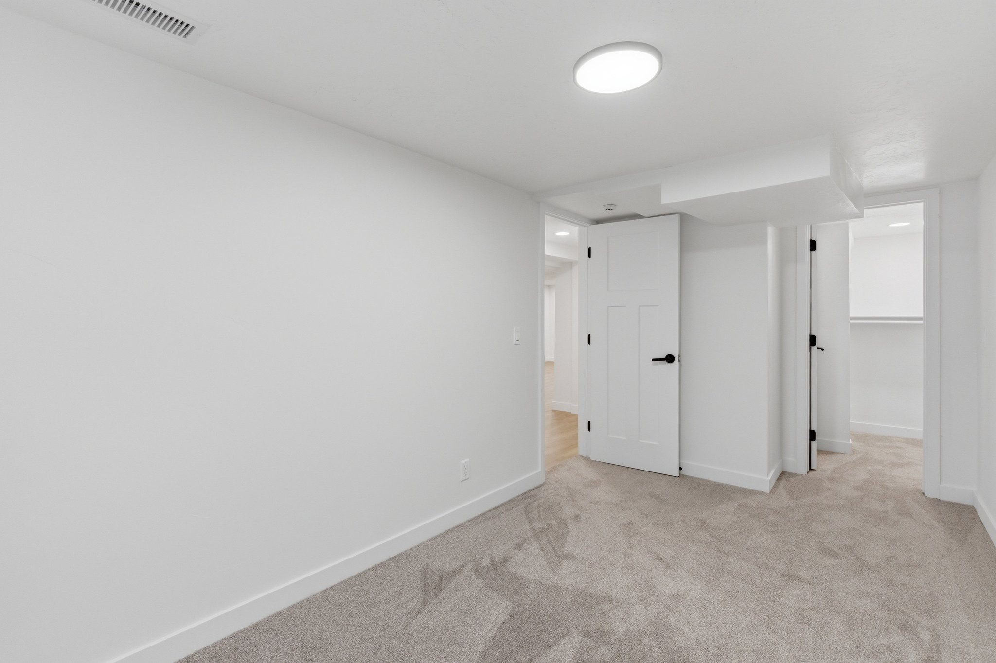 Neutral-toned carpeting and white walls