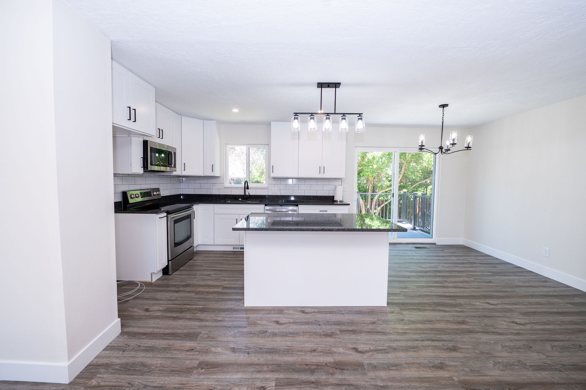Open-concept living space with wood-finish flooring