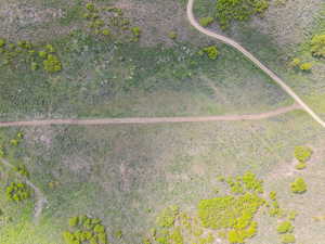 Expansive land parcel featuring natural topography, established dirt paths, and varied vegetation