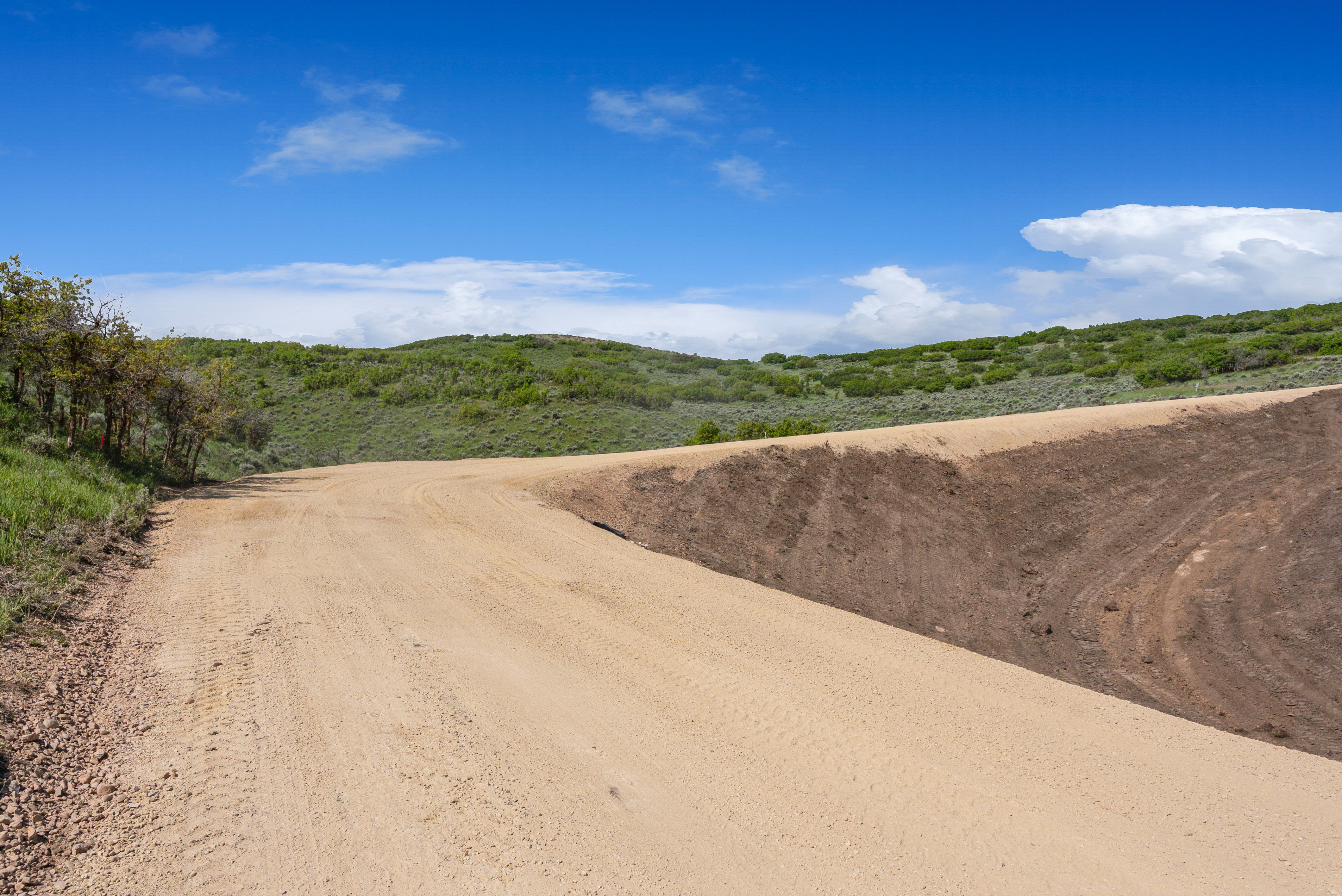 Unpaved road with a substantial natural embankment