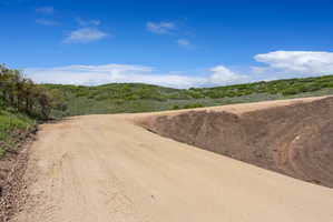 Unpaved road with a substantial natural embankment