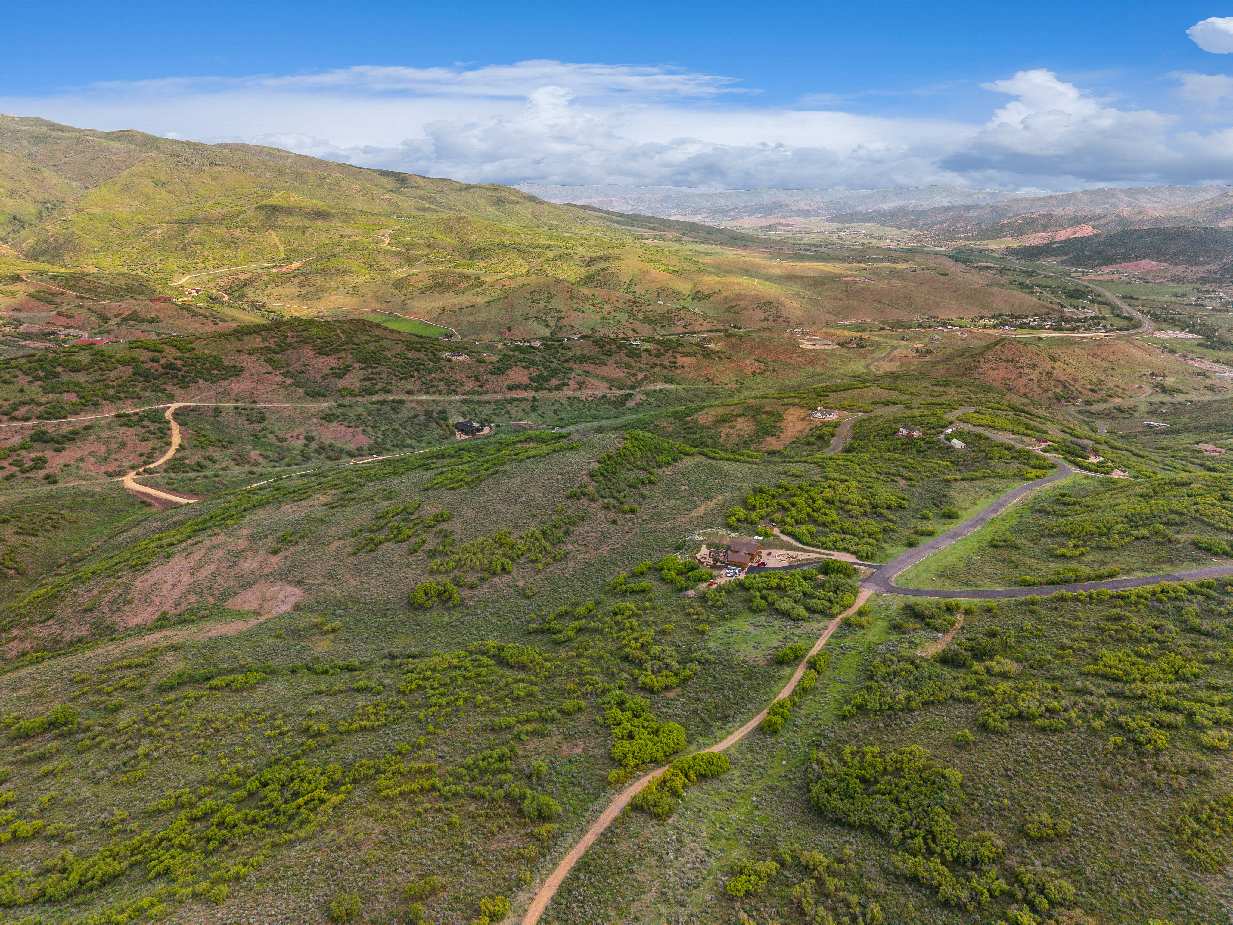 Expansive mountain landscape featuring rolling hills and distant terrain