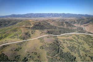 Expansive undeveloped terrain with distant mountain ranges under a clear sky