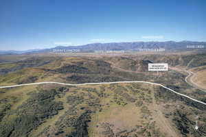 Expansive mountainous landscape featuring distant peaks including Bald Mountain, Jupiter Peak, and Wasatch Back