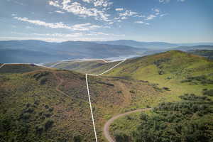 Expansive mountain property featuring rolling hills and distant water