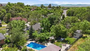 Outdoor swimming pool with surrounding patio space, fenced backyard, and a detached shed