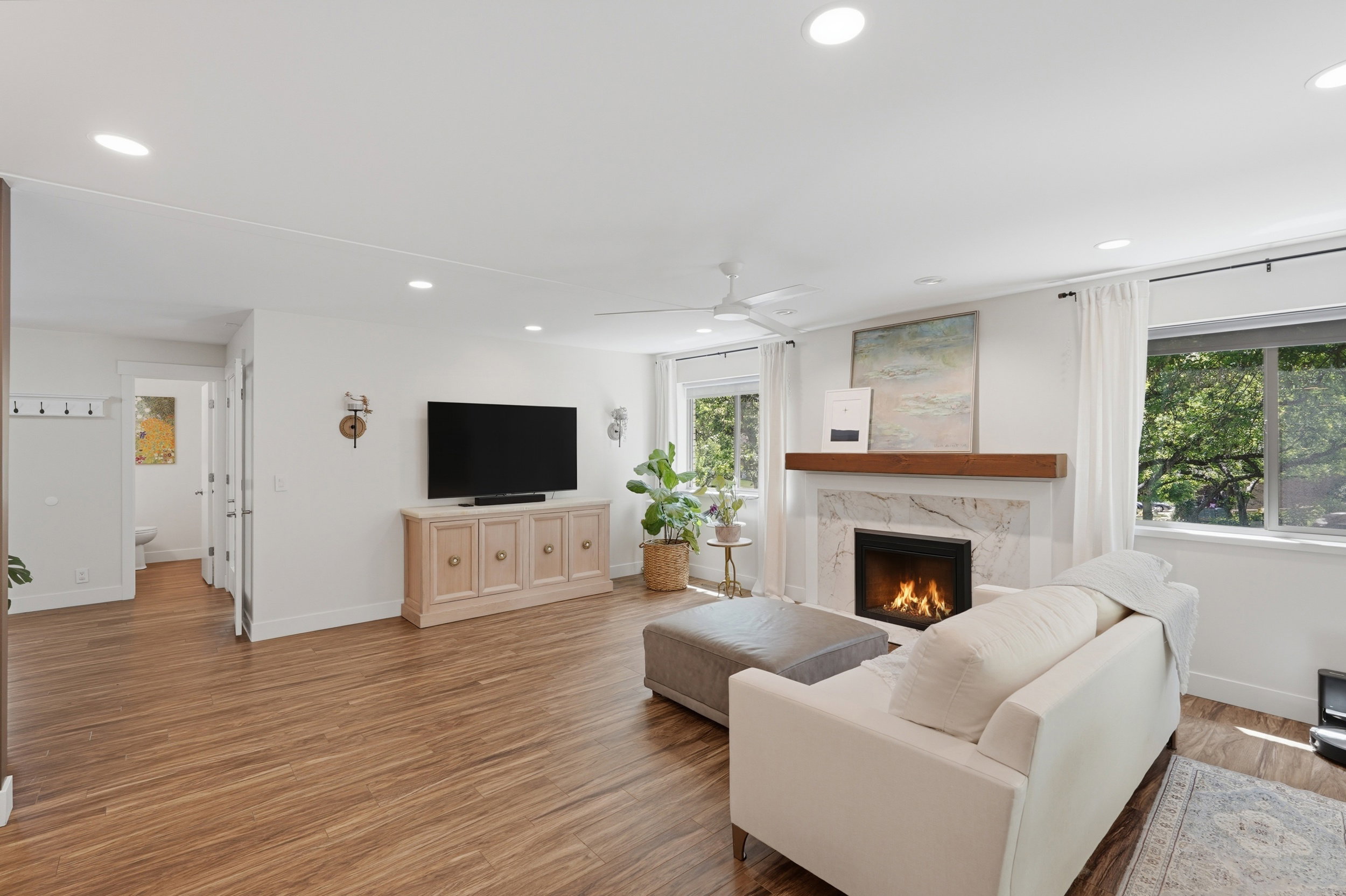 Spacious living area featuring recessed lighting, a ceiling fan, and wood-finish flooring