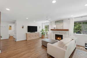 Spacious living area featuring recessed lighting, a ceiling fan, and wood-finish flooring