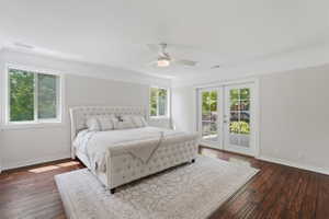 Spacious room featuring rich wood-finish flooring, white trim, and a ceiling fan