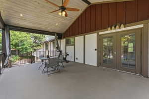 Covered outdoor deck with a vaulted wood-finish ceiling, recessed lighting, and a ceiling fan