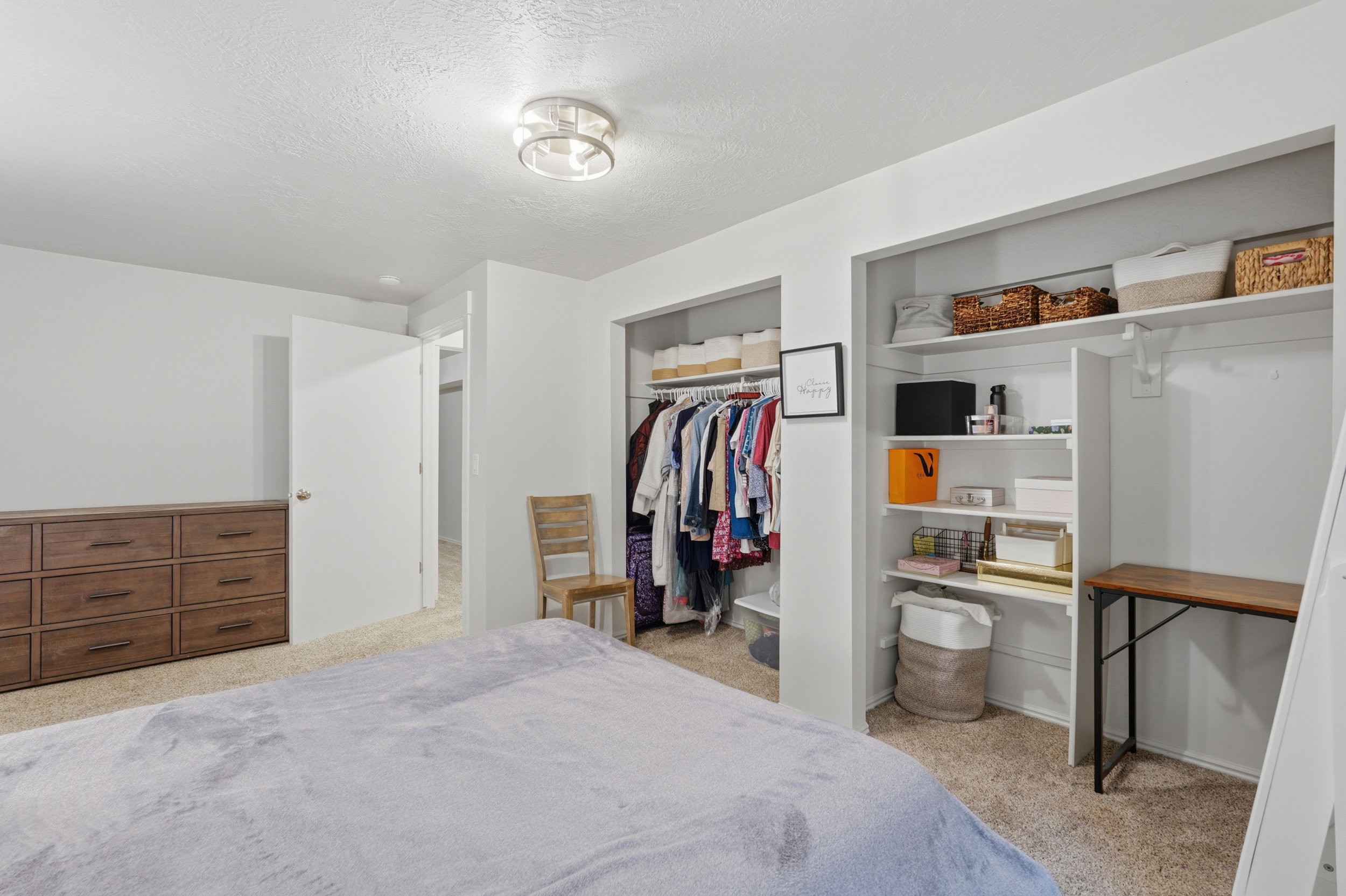 Bedroom featuring textured carpet flooring and a semi-flush mount ceiling light