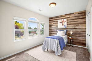 Accent wall featuring horizontal wood paneling, white trim, and a semi-flush ceiling light fixture