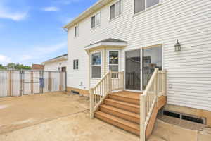 Rear exterior featuring white vinyl siding and a bay window