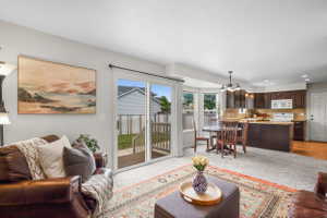 Bright living area featuring sliding glass doors to a backyard deck
