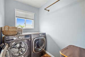 Utility space featuring light blue walls and a window with horizontal blinds