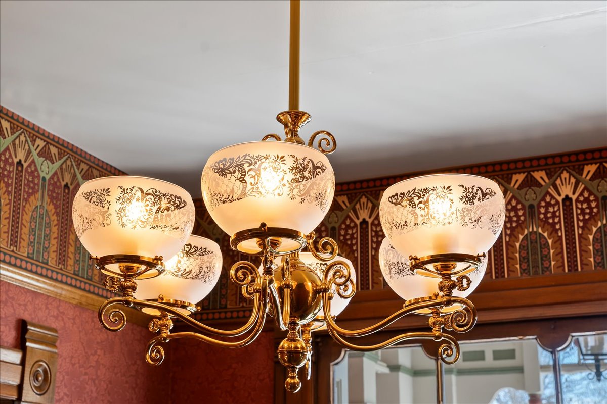 Brass chandelier with five etched glass shades